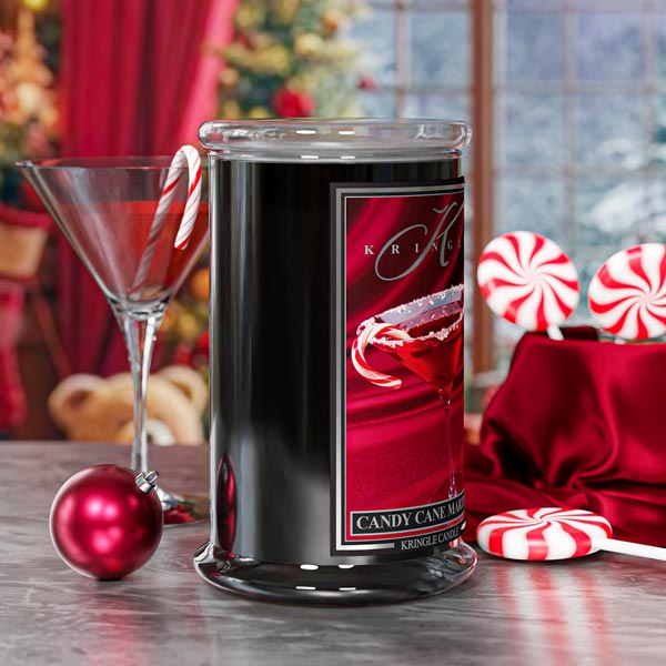 Kringle Candle jar with candy cane theme on a festive table setting.