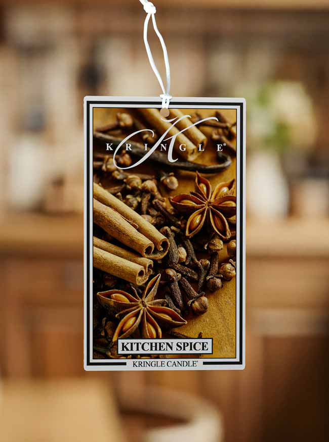 Kringle Candle Kitchen Spice air freshener with cinnamon sticks and star anise on a blurred background