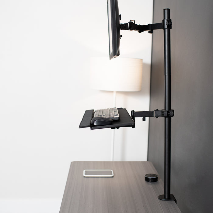 Pole Mount Tilting Keyboard Tray on desk in office space.