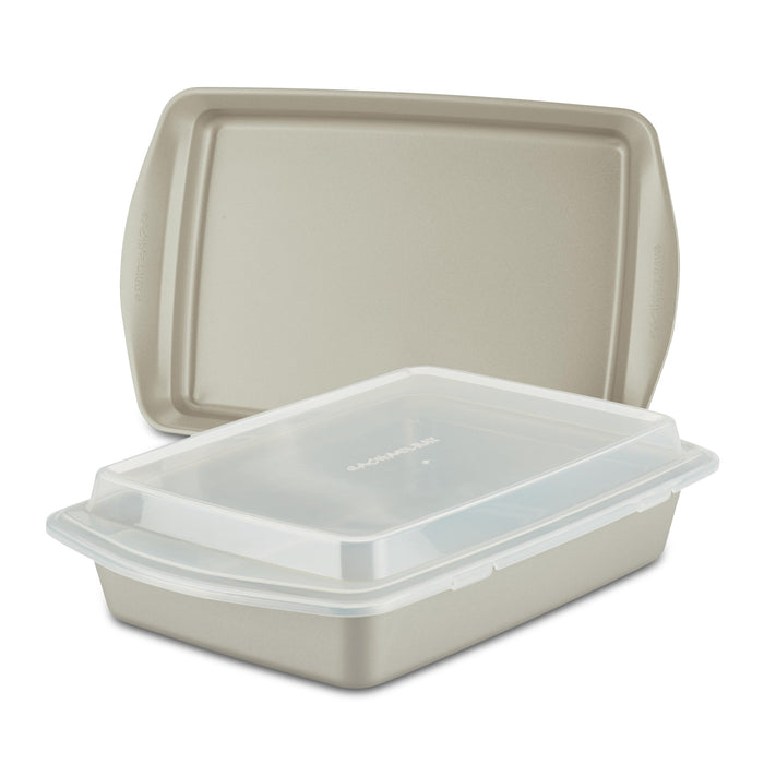 The 3-Piece Nonstick Covered Cake Pan & Baking Sheet Set, featuring a beige pan made from heavy gauge steel, includes a snug-fitting lid that nests inside a larger one, making it ideal for all your baking endeavors.