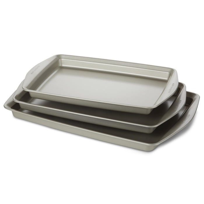 Introducing the "3-Piece Nonstick Jumbo Sheet Pan Set," a collection of three gray baking trays designed to nestle together perfectly. Crafted from heavy gauge steel, these nonstick cookie pans ensure durability and even heat distribution. They are oven safe, meeting all your baking needs with reliable performance every time.