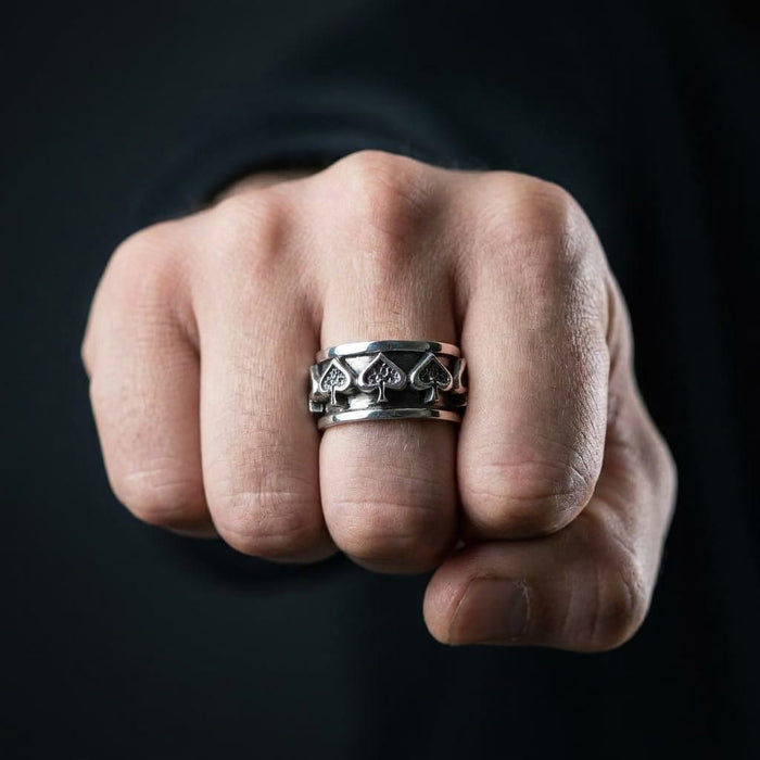 Man wearing ace of spades sterling silver spinner ring on index finger showing fit and scale