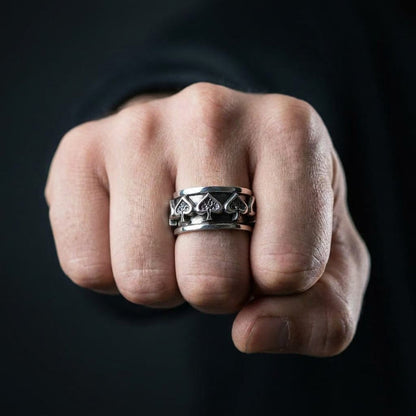 Man wearing ace of spades sterling silver spinner ring on index finger showing fit and scale