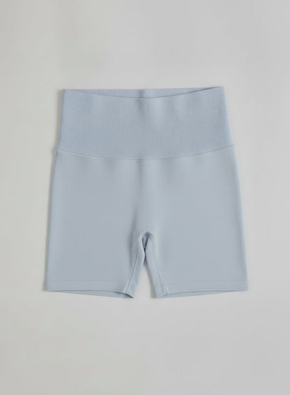 Light blue aim'n Aura Shape Seamless Hotpants featuring a high ribbed waistband in a flatlay.