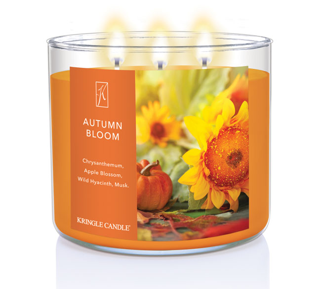 Kringle Candle Autumn Bloom candle with sunflower and pumpkin design on an orange label.