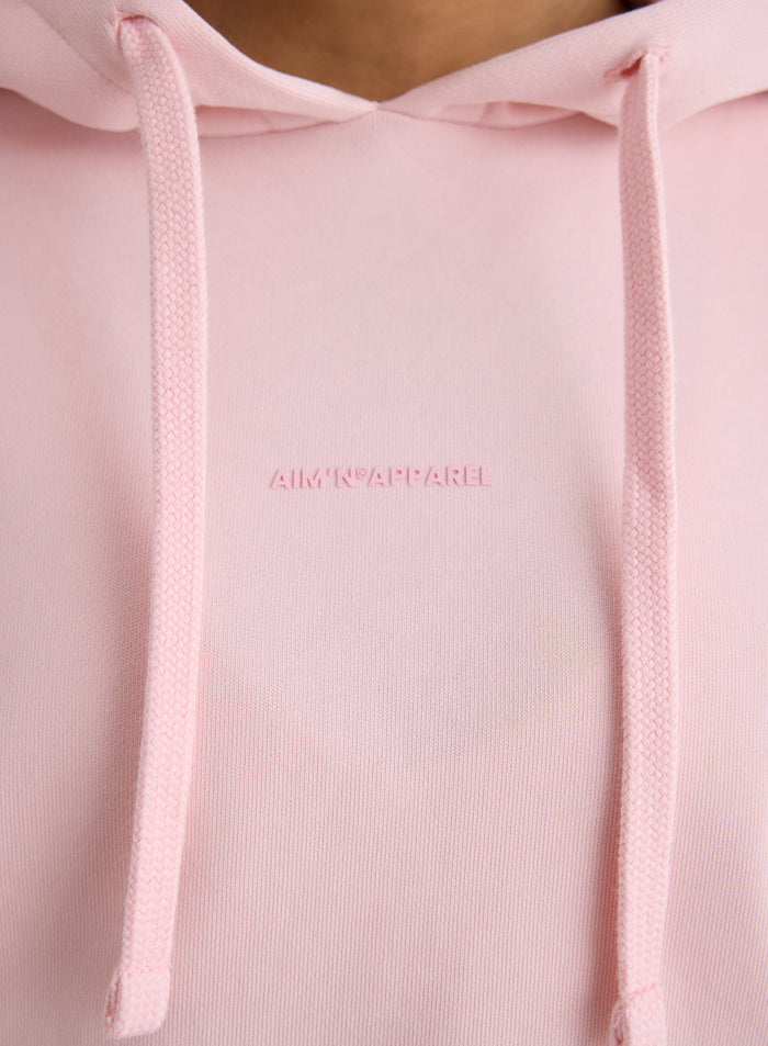 Close-up of the tonal aim'n logo on the pink Apparel Chunky Terry Hood [S-170cm]