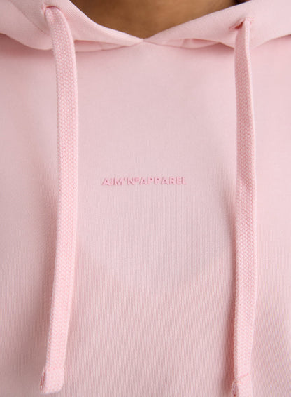 Close-up of the tonal aim'n logo on the pink Apparel Chunky Terry Hood [S-170cm]