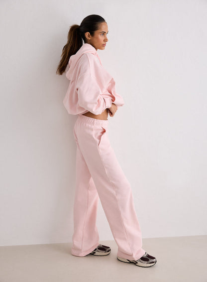 A woman standing in profile wearing pink Ballerina Chunky Terry Sweatpants and a matching hoodie [S-170cm]