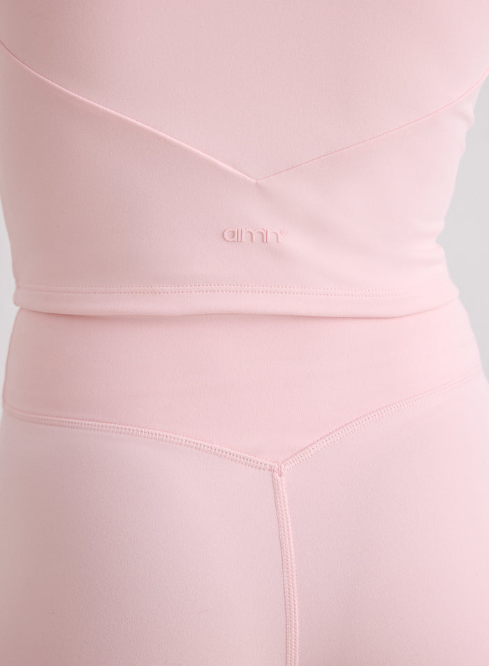 Close-up of the back of the pink Ballerina Sense Bralette and matching tights featuring V-shaped seams and a tonal aim'n logo [XS-170cm]