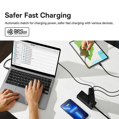 Fast charging system for multiple devices, featuring a laptop, tablet, smartphone, and charging hub.