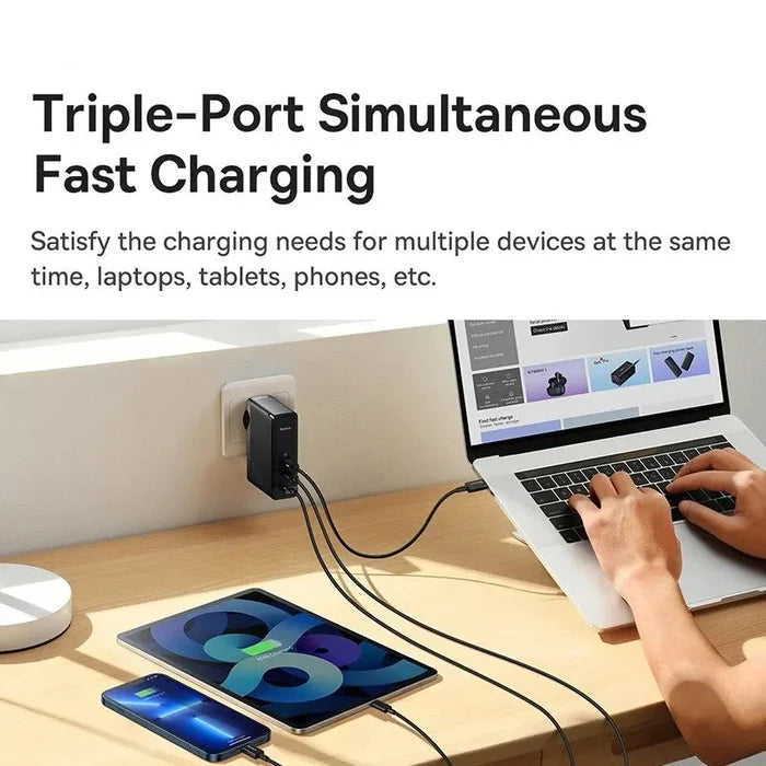 Triple-port fast charging device plugged into a wall outlet, connected to multiple electronic devices on a desk.