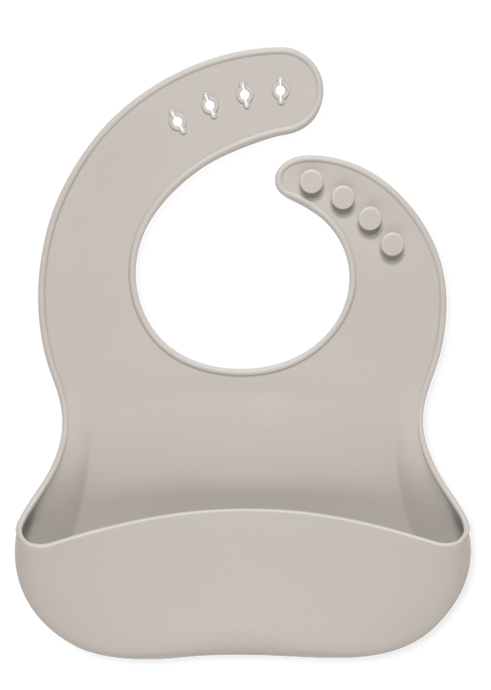 Soft beige bib with light taupe tone on white background