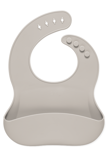 Soft beige bib with light taupe tone on white background