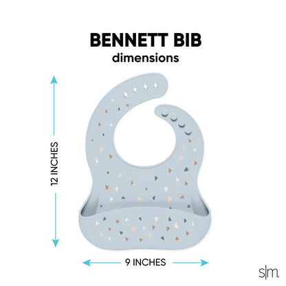 Soft periwinkle silicone toddler bib with light blue-gray tones, featuring a calming and gentle design for mealtime.