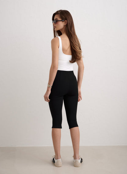 Black Luxe Capri Pants paired with a white tank top by aim'n, shown from a rear view. [34-174cm]