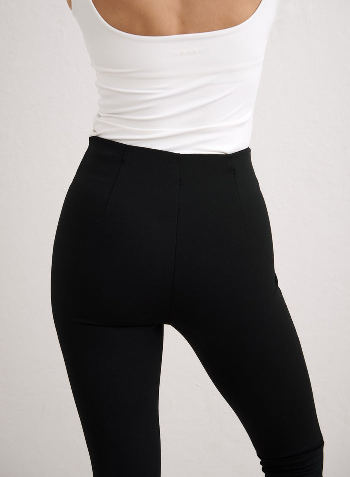 Rear view of high-waisted black Luxe Capri Pants by aim'n, featuring a sleek and tailored fit. [34-174cm]