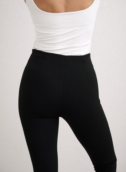 Rear view of high-waisted black Luxe Capri Pants by aim'n, featuring a sleek and tailored fit. [34-174cm]