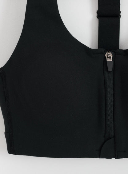 Detail view of the front zipper and adjustable strap on the black Sense High Support Bra by aim'n.