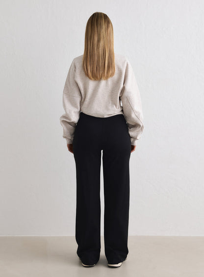 Rear view of black aim'n Sense Tall Pants featuring a relaxed, wide-leg fit and high waist. [M-170cm]