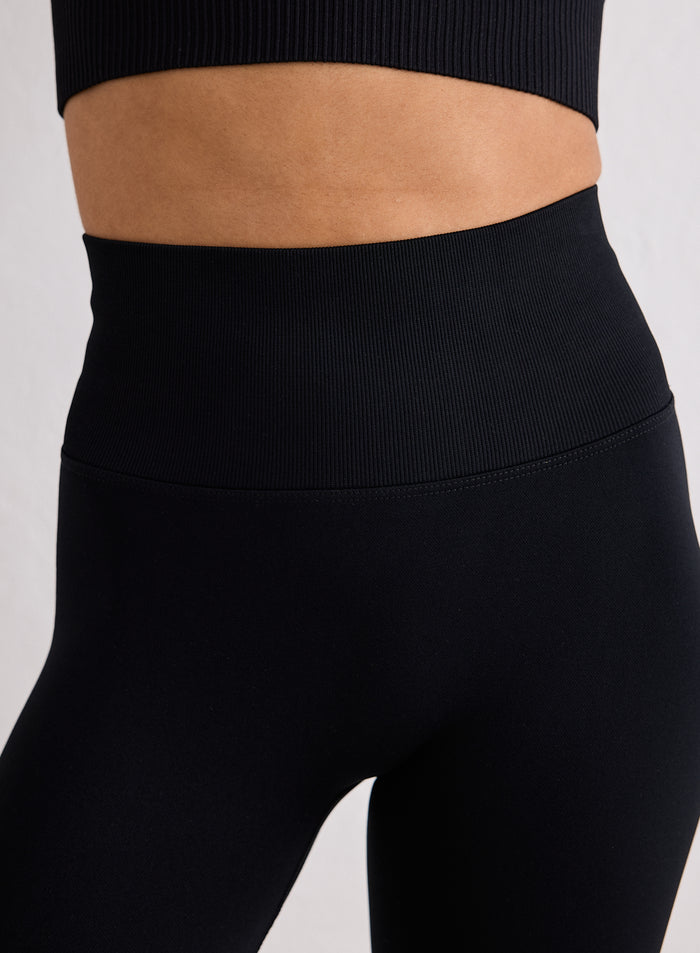 Close-up of the high waistband on black Shape Seamless 7/8 Tights from aim'n [XS-170cm]