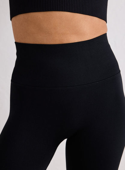 Close-up of the high waistband on black Shape Seamless 7/8 Tights from aim'n [XS-170cm]