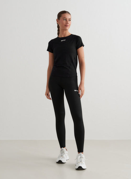 Black Soft Basic Short Sleeve t-shirt with a second skin feel, styled with aim'n leggings and sneakers.