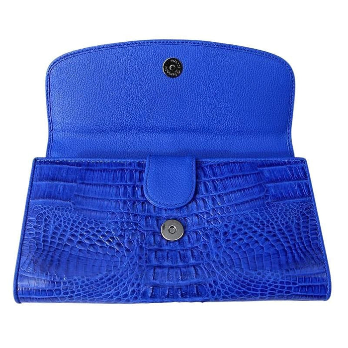 The tri-fold snap closures on the interior of the blue crocodile wallet.
