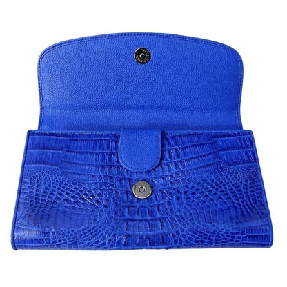 The tri-fold snap closures on the interior of the blue crocodile wallet.