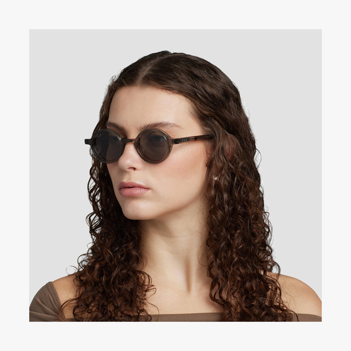 Crystal Sencha / Grey Green Lens | Side view of female model wearing Cairn Sunglasses in Crystal Sencha with Grey Green Lens