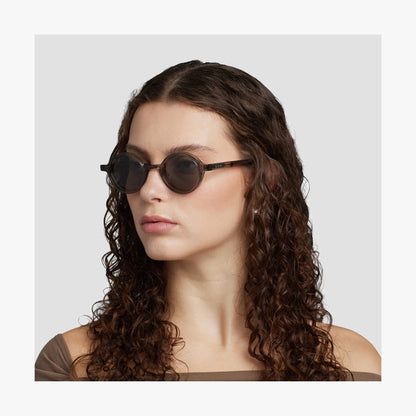 Crystal Sencha / Grey Green Lens | Side view of female model wearing Cairn Sunglasses in Crystal Sencha with Grey Green Lens