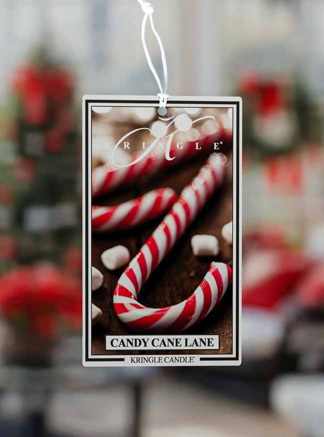 Kringle Candle air freshener for 'Candy Cane Lane' with candy canes and marshmallows on a blurred background.