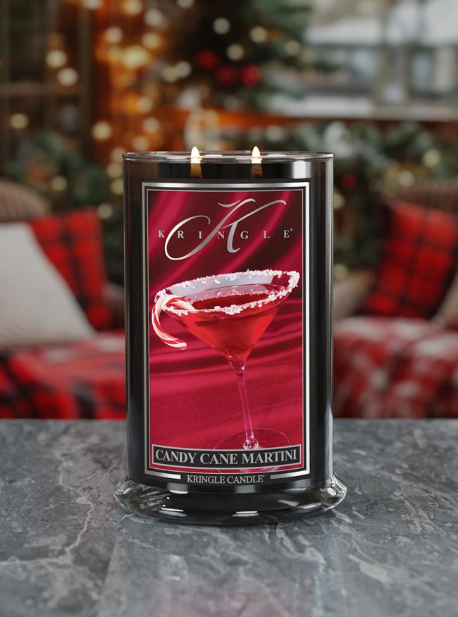 Kringle Candle with 'Candy Cane Martini' design on a table with a festive background.