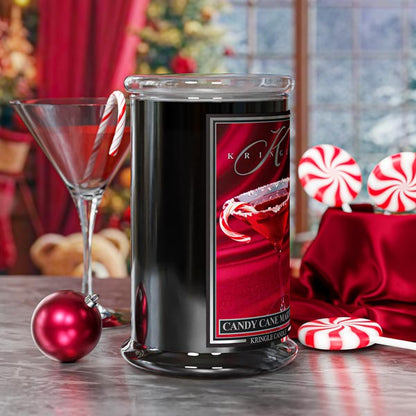 Kringle Candle jar with candy cane theme on a festive table setting.