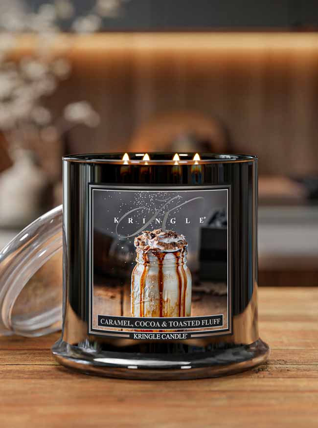 Kringle Candle with 'Caramel, Cocoa & Toasted Fluff' flavor on a wooden surface.