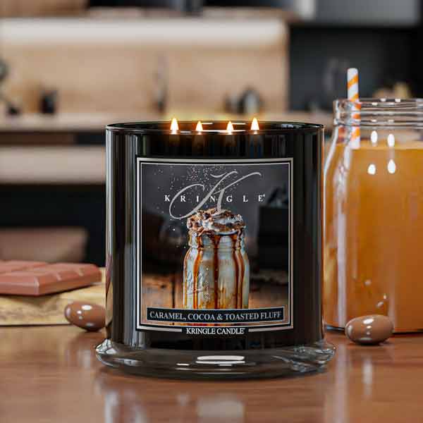 Kringle Candle with a caramel, cocoa, and toasted fluff flavor on a table.