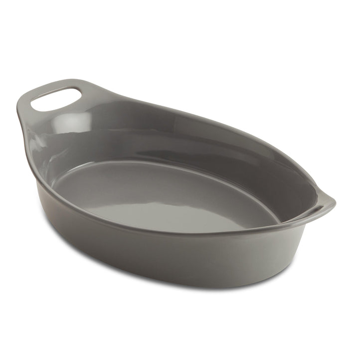 The Ceramic Oval Bakers, featuring a convenient handle, sits empty against a pristine white background. Designed for versatility, it transitions effortlessly from freezer to oven, making your culinary creations both stylish and effortless.