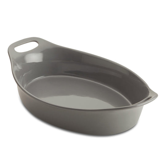 The Ceramic Oval Bakers, featuring a convenient handle, sits empty against a pristine white background. Designed for versatility, it transitions effortlessly from freezer to oven, making your culinary creations both stylish and effortless.
