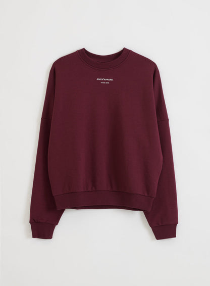 Relaxed cherry red terry sweatshirt by aim'n with ribbed cuffs and a silver logo on the front.