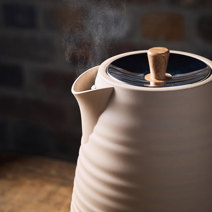 Beige ceramic Kettle with wooden handle and lid, steam rising against a dark background
