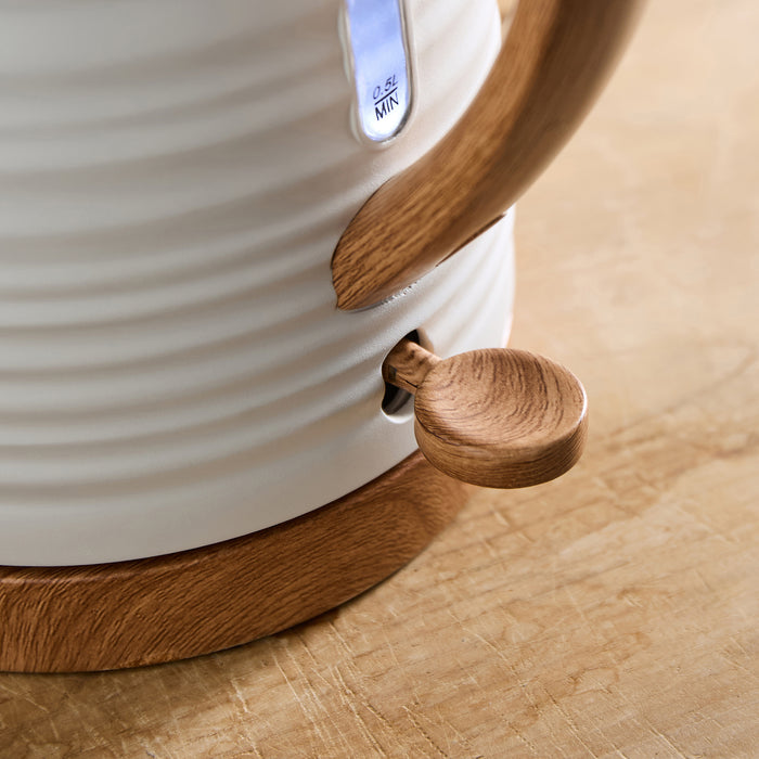 White Kettle with wooden accents on a wooden surface