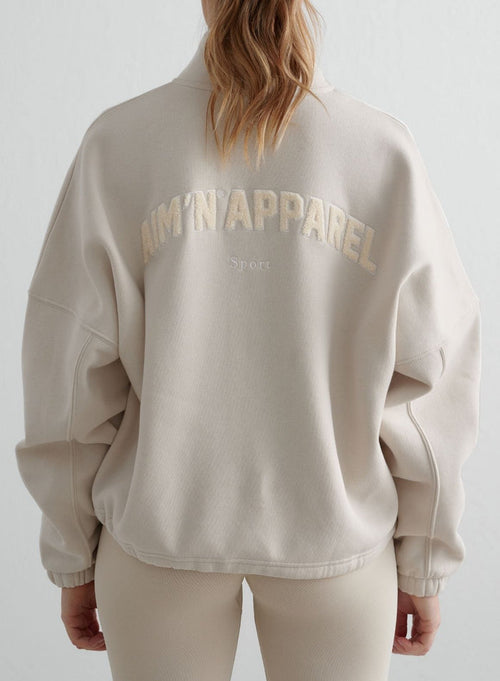 Back view of the clay Campus Sweat Zip Jacket from aim'n, featuring textured teddy artwork for a cozy look.