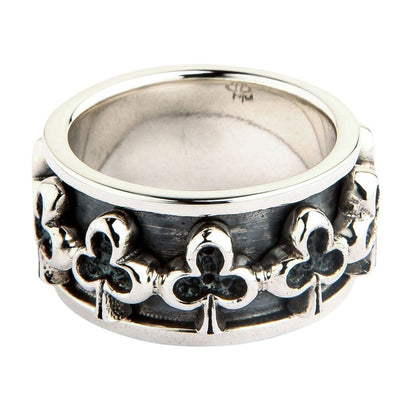 Club sterling silver spinner ring front view showing raised trefoil motifs on oxidized band