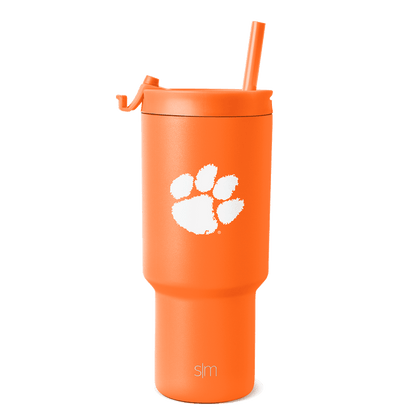 Bright orange tumbler with white paw print graphic and brand text