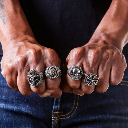 A sterling silver and gold-accent crucifix biker ring, featuring a detailed figure of Jesus and surrounded by gothic scrollwork.