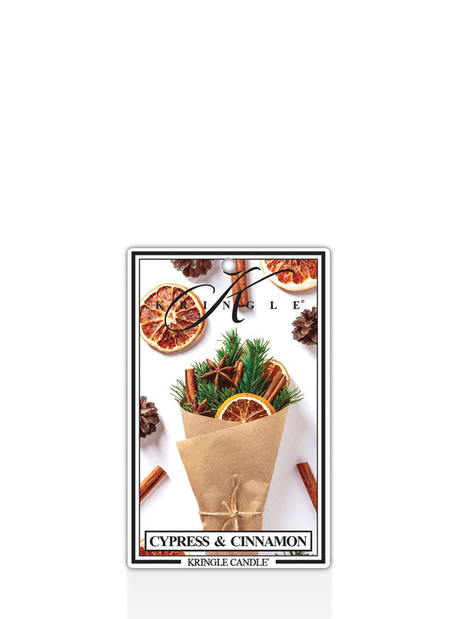 Kringle Candle Cypress and Cinnamon air freshener with cypress and cinnamon elements on a white background