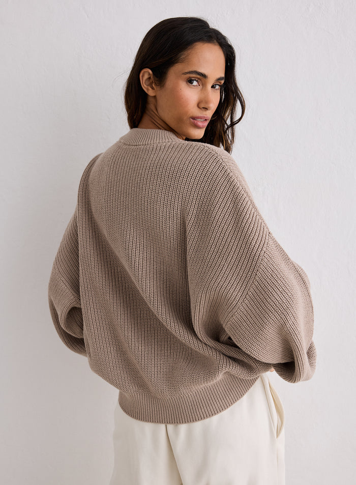 Rear view of a woman looking over her shoulder wearing a Dark Clay Knitted Sweatshirt [S-170cm]