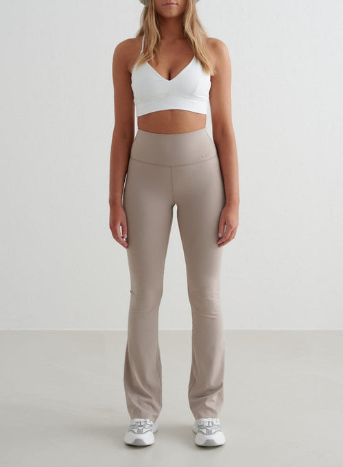 Dark Clay aim'n Sense Flare Tights with a high waist, flared leg, and squat proof second skin feel.