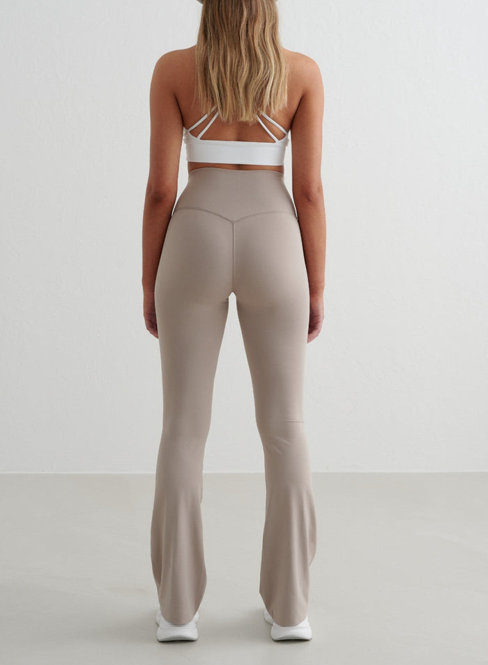 Dark Clay Sense Flare Tights by aim'n featuring a high waist, second skin feel, and squat proof flared leg, back view.