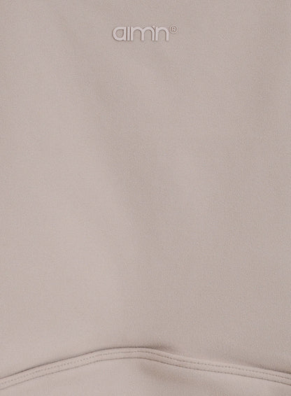 Dark Clay Sense Sports Bra detail showing the soft brushed fabric and printed aim'n logo.