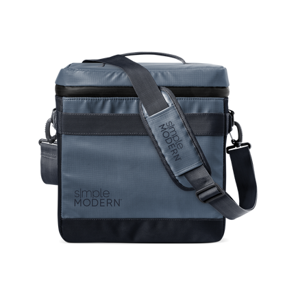 Slate blue-gray crossbody bag with black webbing strap and black accent details, modern neutral design